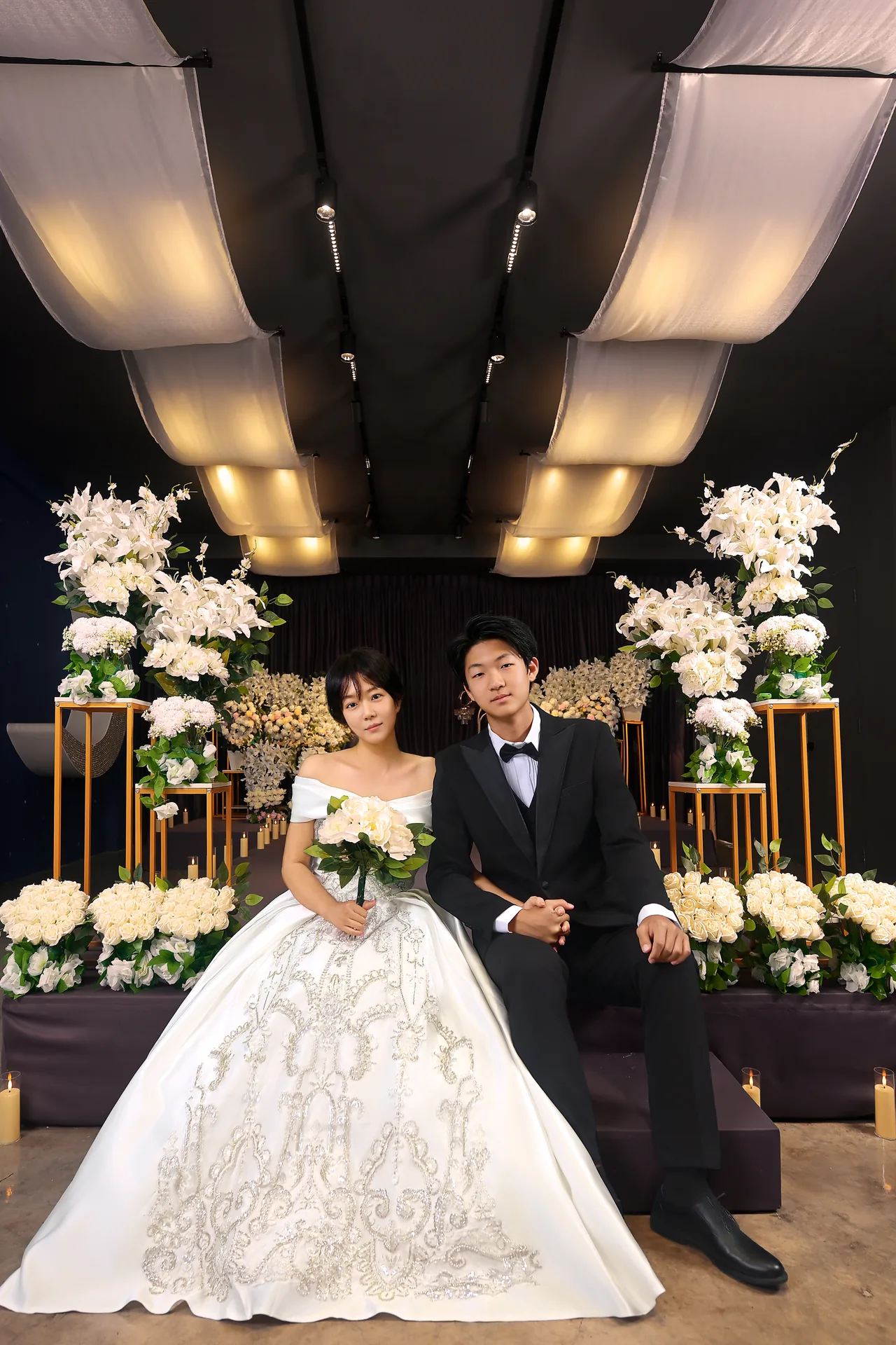 Wedding couple seated on the ceremony stage